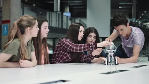 Five Children working with small robot at school