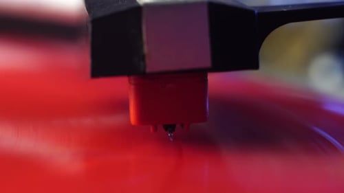 Placing Crystal Gramophone Needle on Vinyl Record Spinning on Turntable, Close Up
