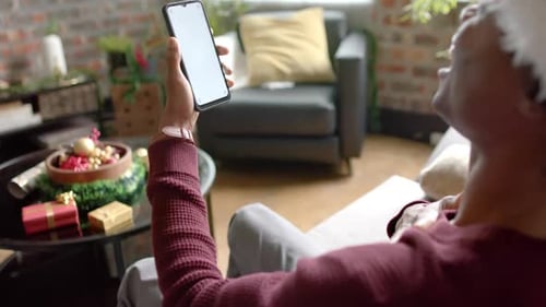 Man in Santa Hat Using Phone for Video Call