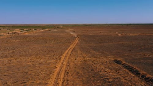 A motorcyclist returns to a moto camp in the desert after a race