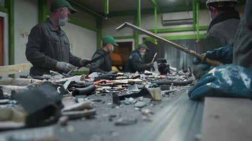 Workers Sorting Materials on Recycling Conveyor Belt