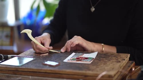 A woman making a stained glass work