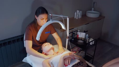 Skincare Session Overview Relaxing Facial Treatment in Clinic Beautician Massages Neck and Jaw Under