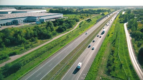Aerial top view of highway road. Drone view of the elevated road, traffic junctions, and green garde
