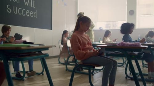 Diverse Children Group Using Digital Tablets at Lesson in School. Students Studying