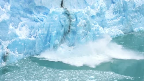 Glacier Ice Collapse Into Ocean Water, Close Up. Global Warming and Climate Change Concept