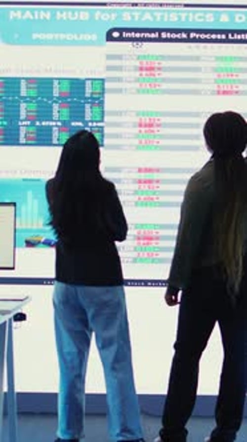Vertical Video Diverse Team of Analysts Examining Monthly Cost and Revenue Elements