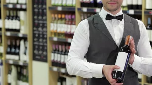 Man Holding Wine Bottle in a Store