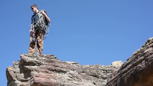 Climber Looks Off Edge of Cliff Activity