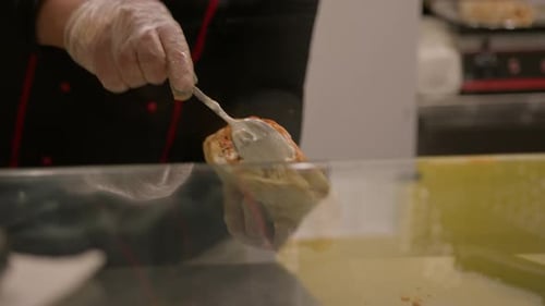 Chef making pita with roasted chicken meat on table - summer food market. Cooking, gastronomy