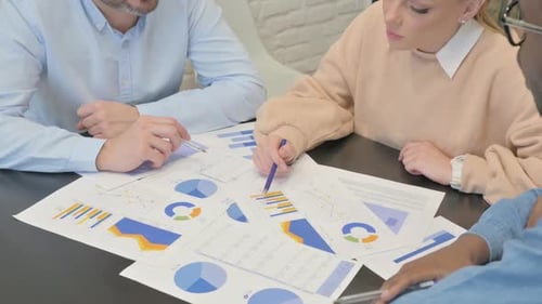 Close up of Mixed Race Business People Working on Documents