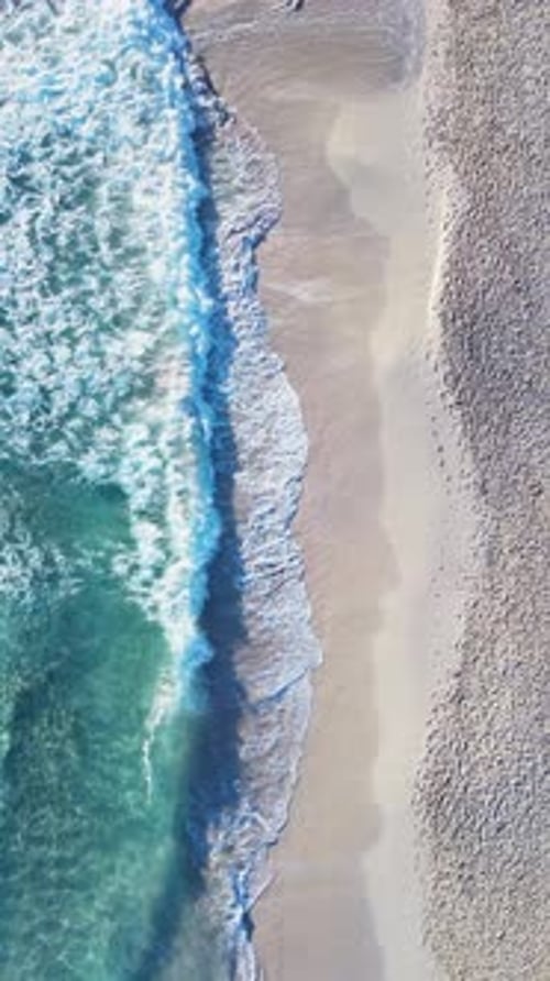 Beach shore waves top view aerial shot