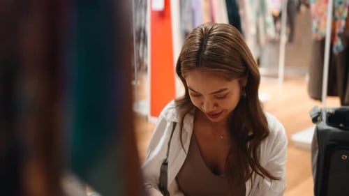 Young Asian Woman Shopping for Clothes in a Retail Store