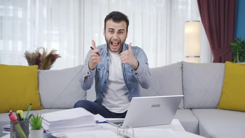 Young Man Working on Laptop at Home