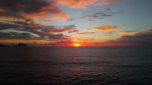 Scenic Sunrise Over the Open Sea with Vibrant Orange Pink and Red Tones Lighting Up the Sky and