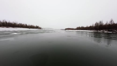 The Tranquil Beauty of the First Snow Covering the Still River in Winter's Embrace