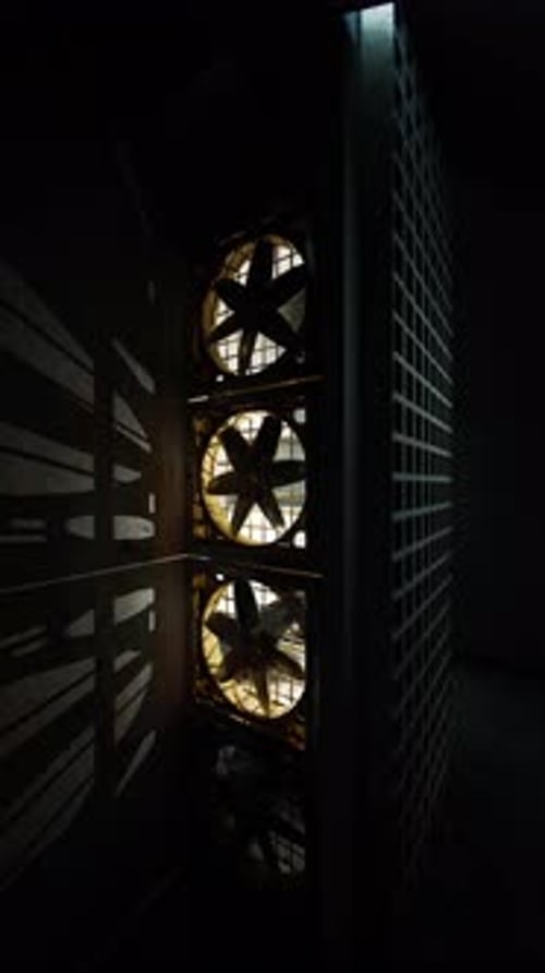 Captivating Shadows and Light From Industrial Fans in a Dark Space