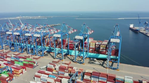 Drone Shot at Loading and Unloading a Container Ship in a Cargo Sea Port
