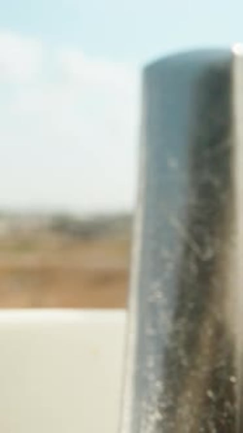 Silver Spoon Stirring Brown Liquid in White Bowl