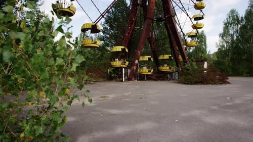 Ferris wheel with yellow baskets in Pripyat, close up tilting up view