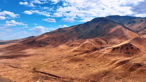 Aerial View of Desert Mountains and Blue Sky