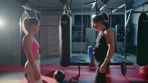 Man and Woman Talking and Resting at the Gym