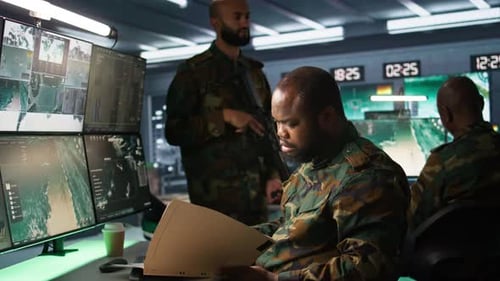 Soldiers Monitoring Surveillance Screens in Control Room