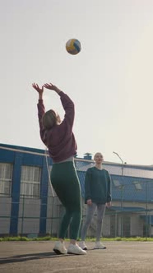 Coach and Volleyball Players in Outdoor Training Session on Court