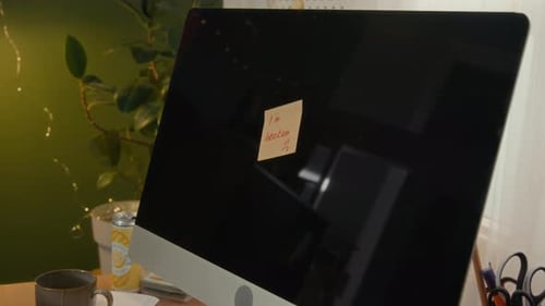 Sticky Note on Screen of Broken Computer in Student Dorm