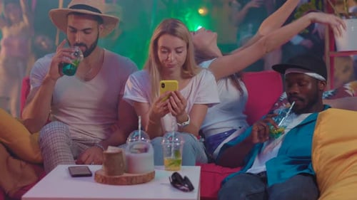 Friends Relaxing at an Indoor Nightclub