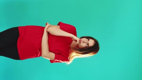 Young Adult Woman Gesturing on Light Blue Background