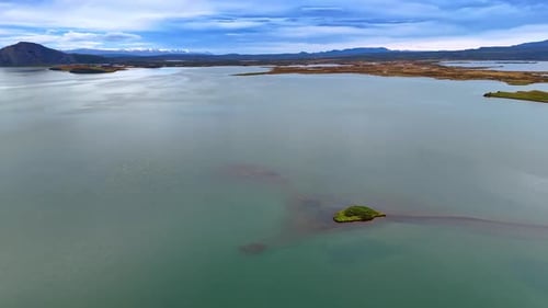 Calm waterscape with transparent water and some little islands in it.