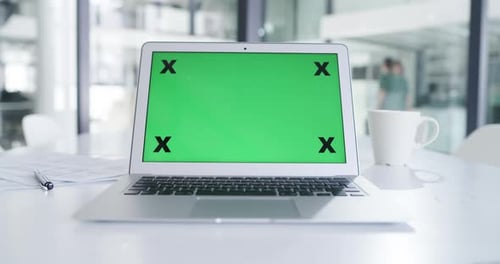4k video footage of a laptop with a green screen in an office