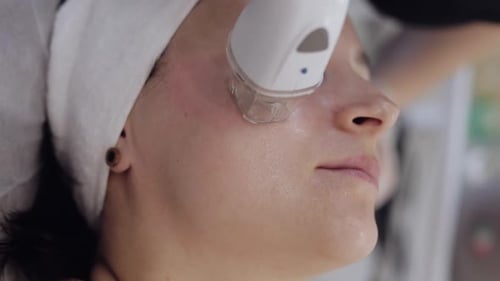 Beautician Makes Woman RF Lifting Cosmetology Procedure of Face and Neck Area Collagen Mask at Spa