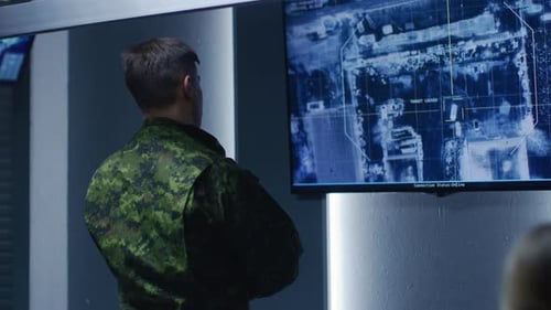 Man in Military Uniform Analyzing Target Locked Display