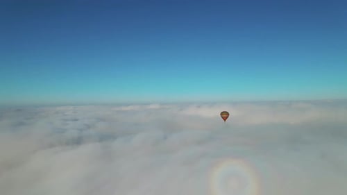 Aerial Birdseye View Shot of Fantastic Cloudscape and Sunny Bright Sky Hot Air Balloon Flowing