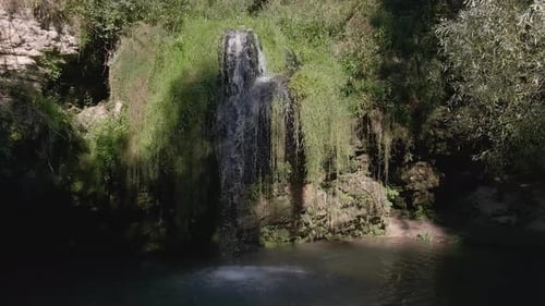 Aerial View of a Hidden Waterfall Lagoon Surrounded by Foliage