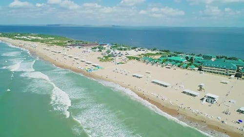 Aerial Over the Long Sandy Spit with a Beach and Azure Water on a Sunny Summer Day Waves Crashing to
