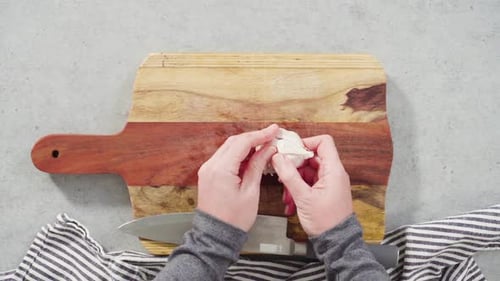 Cutting Organic Garlic on a Wood Cutting Board