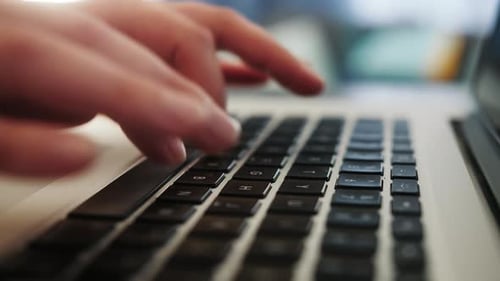 Close Up of a Person's Hands Typing on a Laptop Keyboard Indoors