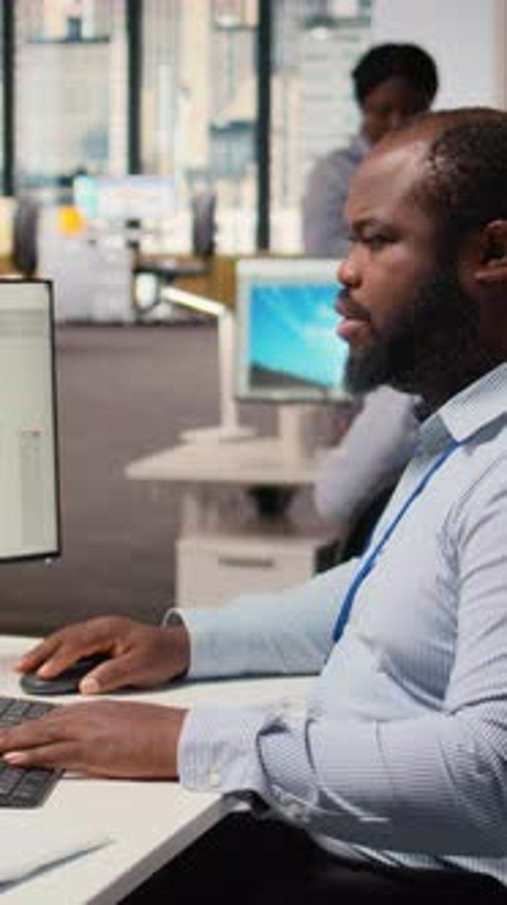 Technician Using CAD Program on PC to Optimize Wind Turbine Design ...