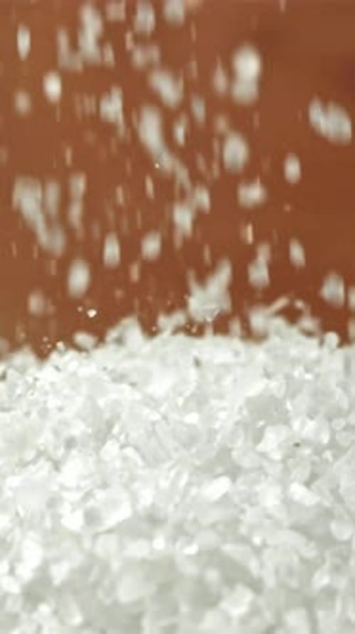 Salt Crystals Fall Into a Pile Filmed on a Highspeed Camera at 1000 Fps