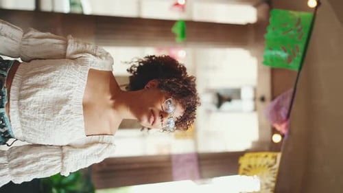 Smiling Woman Standing by Colorful Decoration