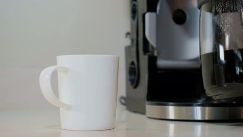 A Hand Pour Coffee in Cup and Takes a White Cup with Coffee From the Table Close Up Shot