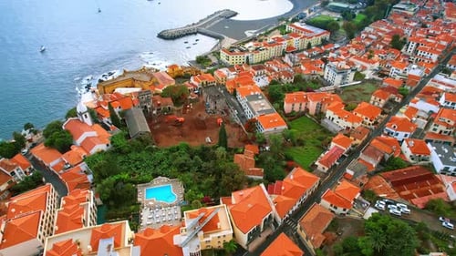 Drone footage above the orange roofs of numerous villas. Cityscape of Madeira, Portugal