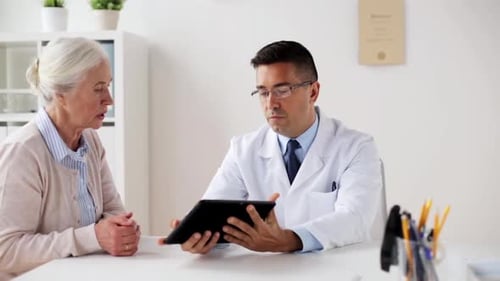 Doctor Discussing Results with Senior Patient on Tablet