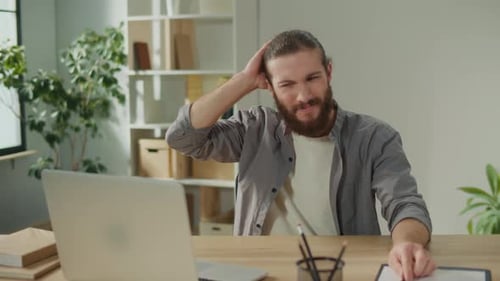 Man Working at Laptop is Tired and Stressed
