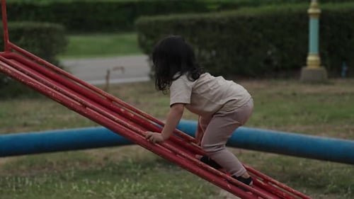 toddler baby girl playing on playground slide