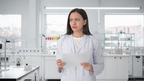 Worried Scientist Reads Documents in Modern Lab