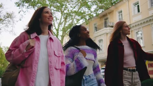 Three Young Women Enjoy a Leisurely Walk Through the Bustling City Embracing Friendship and the